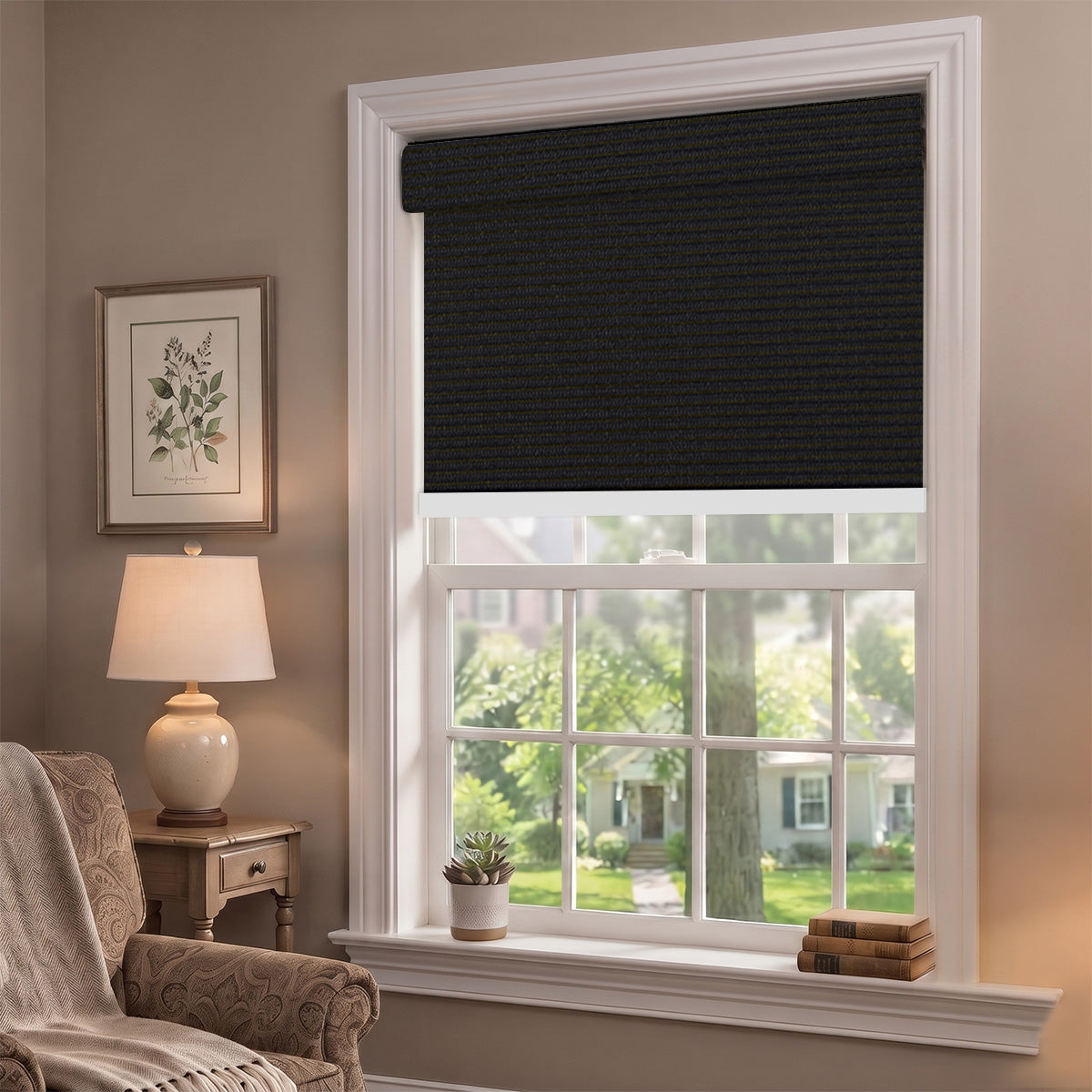 Black motorized blackout roller shade lowered on a tall double-hung window in a traditional sitting room