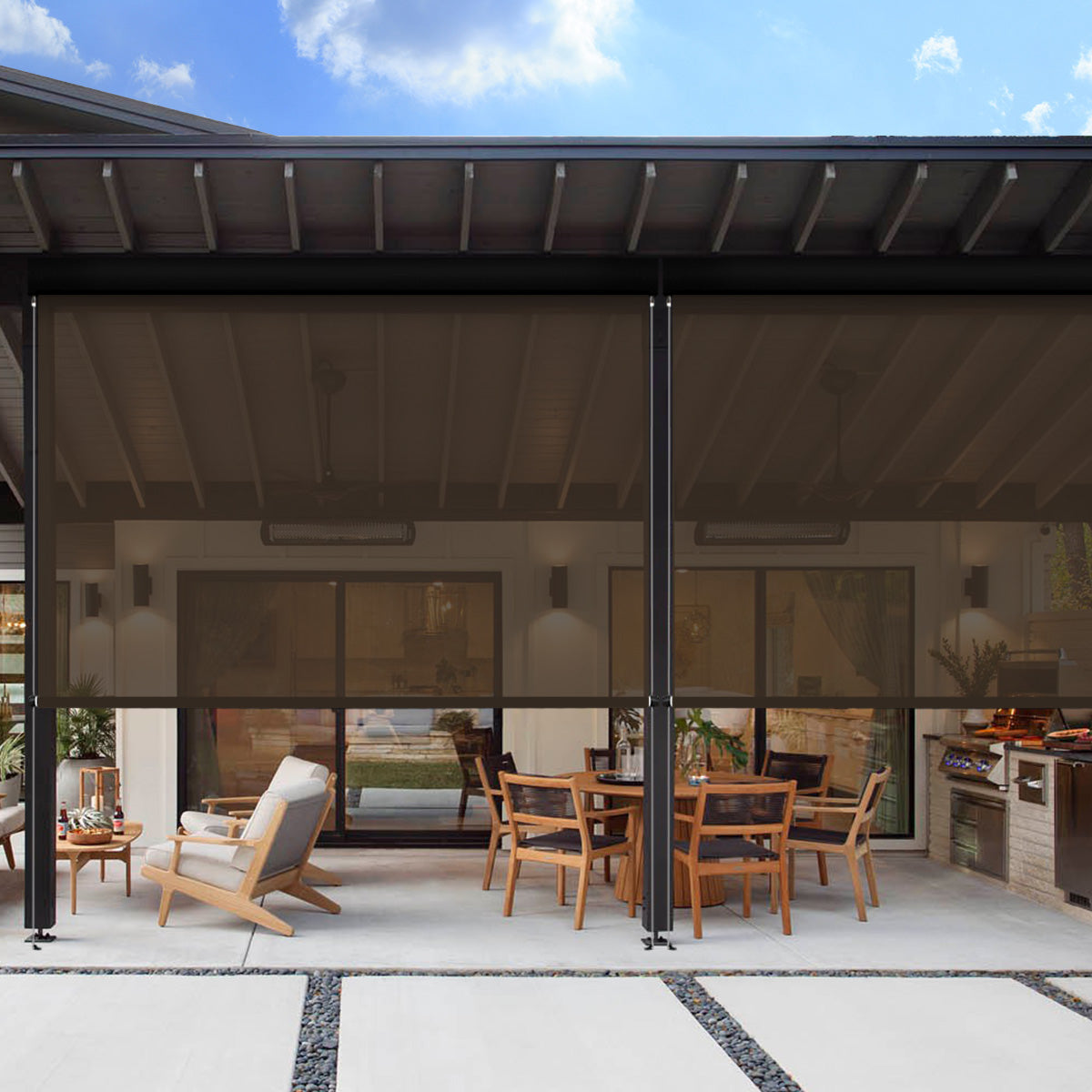 Dark brown motorized outdoor shades lowered across a modern covered patio with dining table and lounge chair