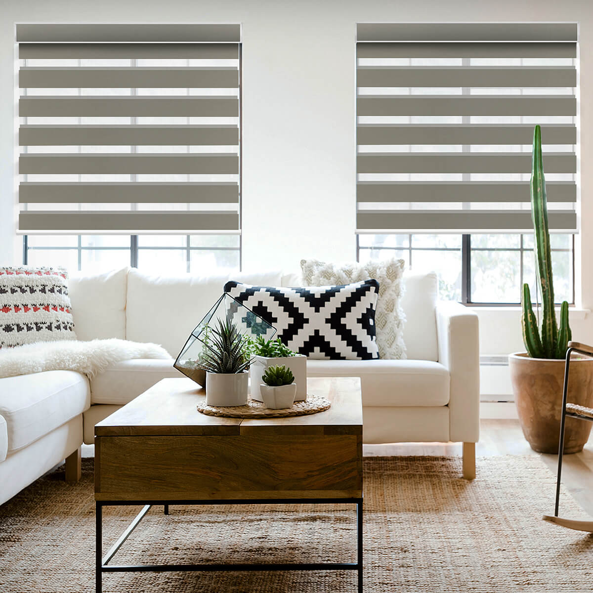 Motorized zebra shades with alternating sheer and solid bands in a bright living room