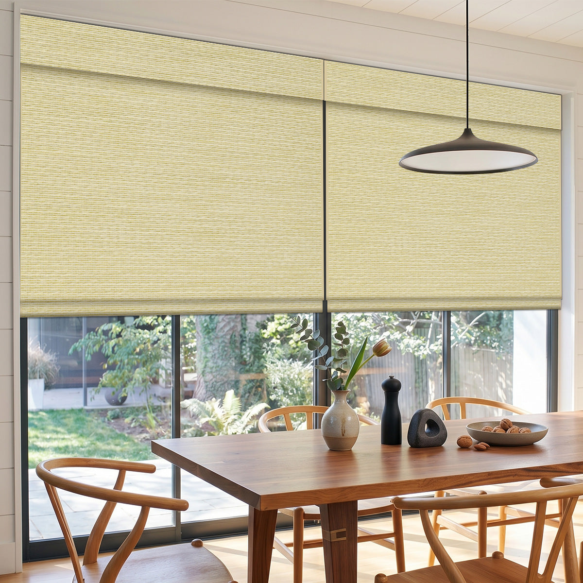 Mist Light Brown woven wood shades over large dining room windows above a wood table and chairs