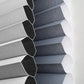 Close-up of a striped fabric blind showcasing elegant gray and blue patterns in soft light.