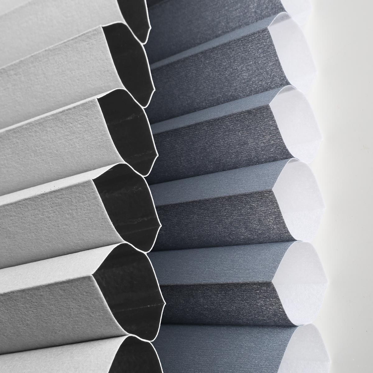 Close-up of a striped fabric blind showcasing elegant gray and blue patterns in soft light.