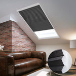 Skylights with blinds above a cozy bed, set against a warm-toned exposed brick wall.