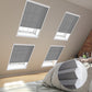 Cozy bedroom with skylights covered by blinds, showcasing a comfortable bed adorned with soft pillows.