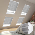 Cozy bedroom with skylights covered by blinds, showcasing a comfortable bed adorned with soft pillows.